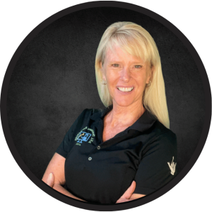 Portrait of Cynthia Long, founder of ASL Teaching Resources, smiling in a black polo shirt with ASL logo.